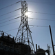 The sun shines above a natural gas-fired electric power generating unit from the 1950s, cooled using a seawater once-through cooling system, at AES Alamitos in Long Beach, California on September 16, 2022.
